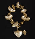 Bracelet of large white and small gold metallic baroque pearls on gold chain and one pair at cl…