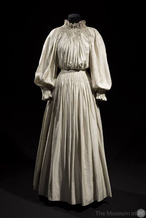 Off-white pinstriped floor length two-piece dress with long puffed sleeves, unstructured bodice…