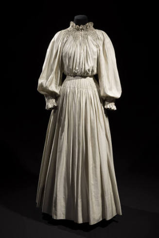 Off-white pinstriped floor length two-piece dress with long puffed sleeves, unstructured bodice…