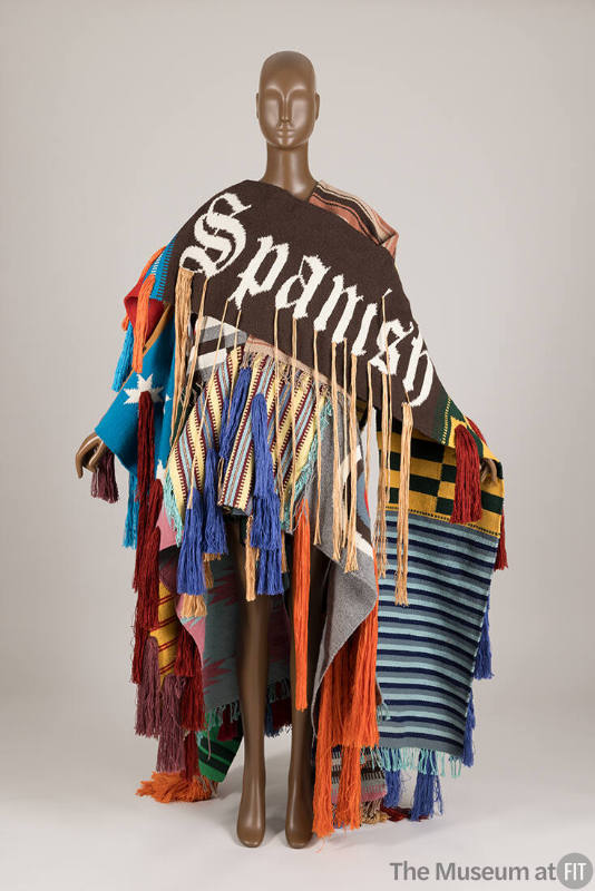 Deconstructed wrap coat consisting of many multicolor panels in a variety of weaves with tufted…