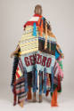 Back view of wrap coat showing multicolor panels in a variety of weaves and light blue panel wi…