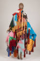 Side view of wrap coat showing multicolor panels in a variety of weaves and light brown panel w…