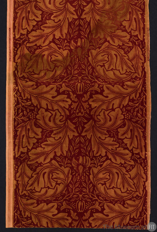 Rectangular dark red textile with light brown double row of stylized leaves and floral motifs i…