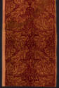 Rectangular dark red textile with light brown double row of stylized leaves and floral motifs i…
