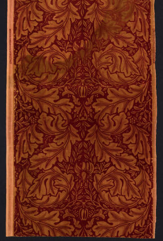 Rectangular dark red textile with light brown double row of stylized leaves and floral motifs i…