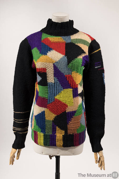Turtleneck sweater with black neck and arms and multicolor purple, red, blue, green, white and …
