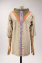 Beige ¾ sleeve tunic top with funnel neck trimmed with a green triangle outlined in orange and …