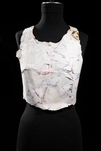 Sleeveless scoop neck bustier made of molded white cardboard with traces of print writing and f…