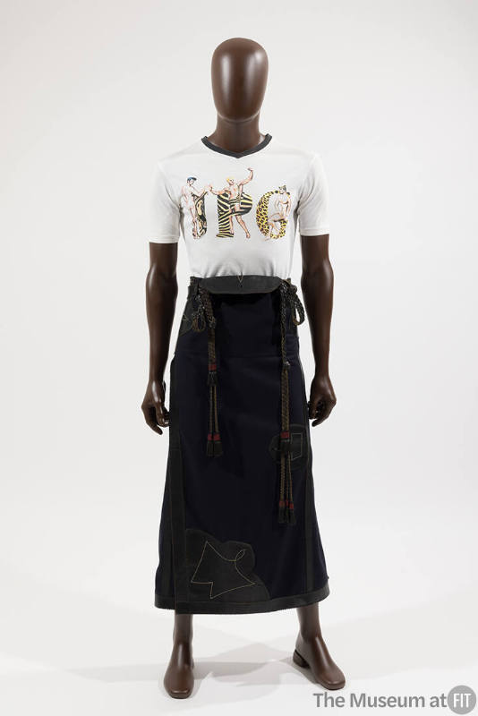 Man’s white short sleeve t-shirt with animal print JPG and three male figures and navy blue ank…