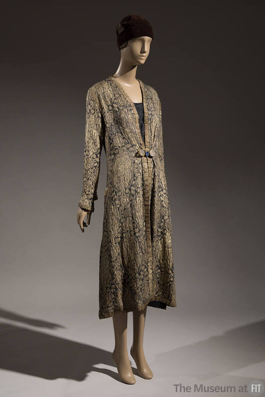 Gold and black brocade evening coat with allover Oriental style patterns and gold braid trim dr…