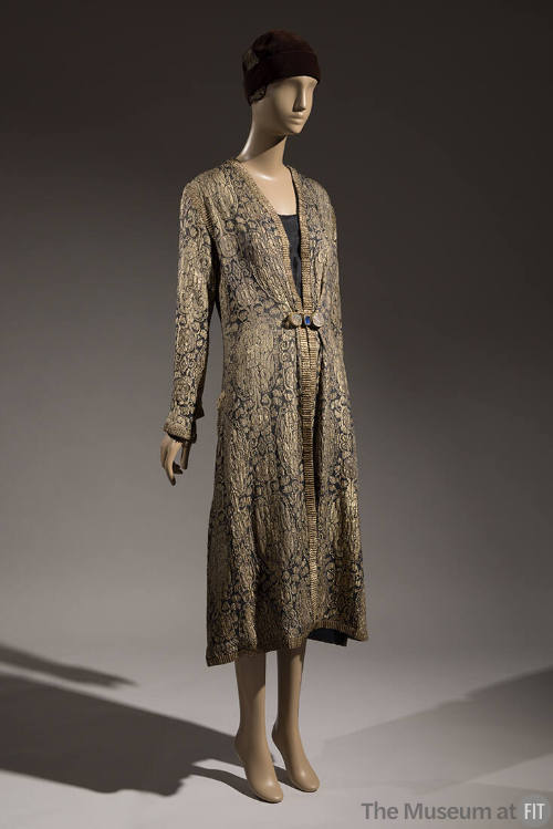 Gold and black brocade evening coat with allover Oriental style patterns and gold braid trim dr…