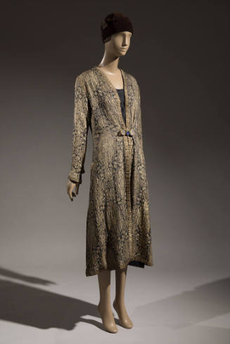 Gold and black brocade evening coat with allover Oriental style patterns and gold braid trim dr…