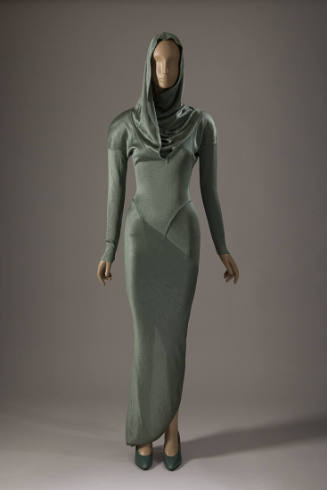 Green ankle length long sleeve sheath dress with hood, cowl neck and seams across forearms and …