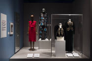 Dress, Dreams and Desire exhibition installation view of two dressed mannequins on a platform a…