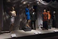 Dress, Dreams and Desire exhibition installation view of six dressed mannequins on a platform 