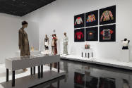 Art X Fashion exhibition installation view of dressed mannequins on white platforms, accessorie…