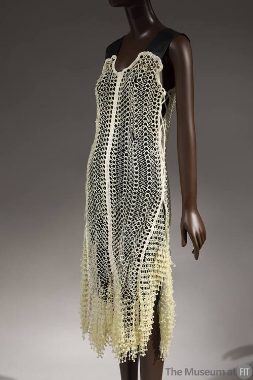 Off-white 3D-printed dress; plastic circular links crocheted with cotton, wide black leather sh…