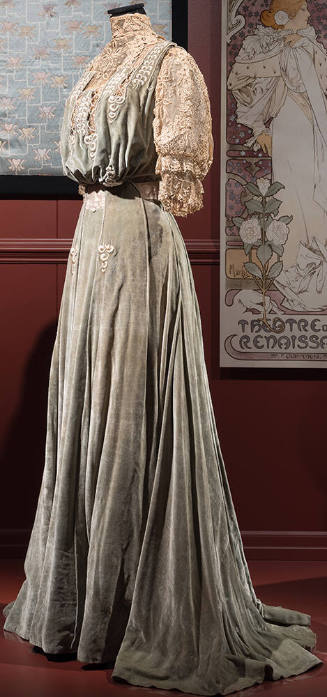 Light green velvet floor length dress with high ivory lace collar, yoke and puffed elbow length…