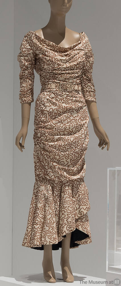 White with brown meandering line print ankle length evening dress with ¾ sleeves, cowl neck and…