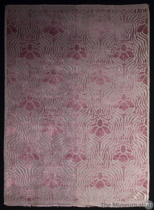 Rectangular velvet textile of purple floral and line motifs on ground that is grey on left and …