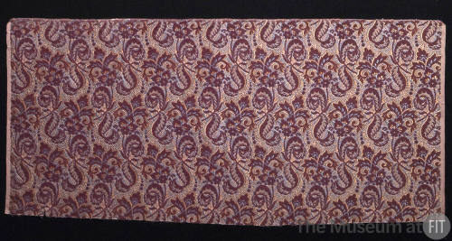 Rectangular velvet textile of red/brown flower leaf and scroll motif on yellow, blue and grey b…