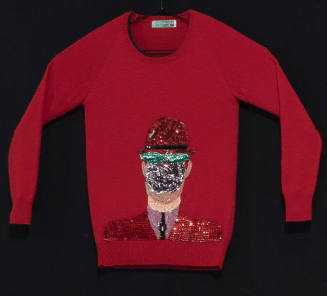 Red sweater with large center appliqué of a covered face wearing a hat in red, black, green, pu…