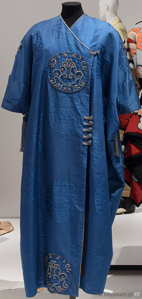 Blue Chinese style evening wrap coat with frog fasteners on upper chest and waist and embroider…