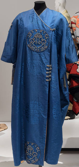 Blue Chinese style evening wrap coat with frog fasteners on upper chest and waist and embroider…