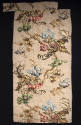 Rectangular brocade textile with floral and branch motifs in brown, green, yellow, blue, red, p…