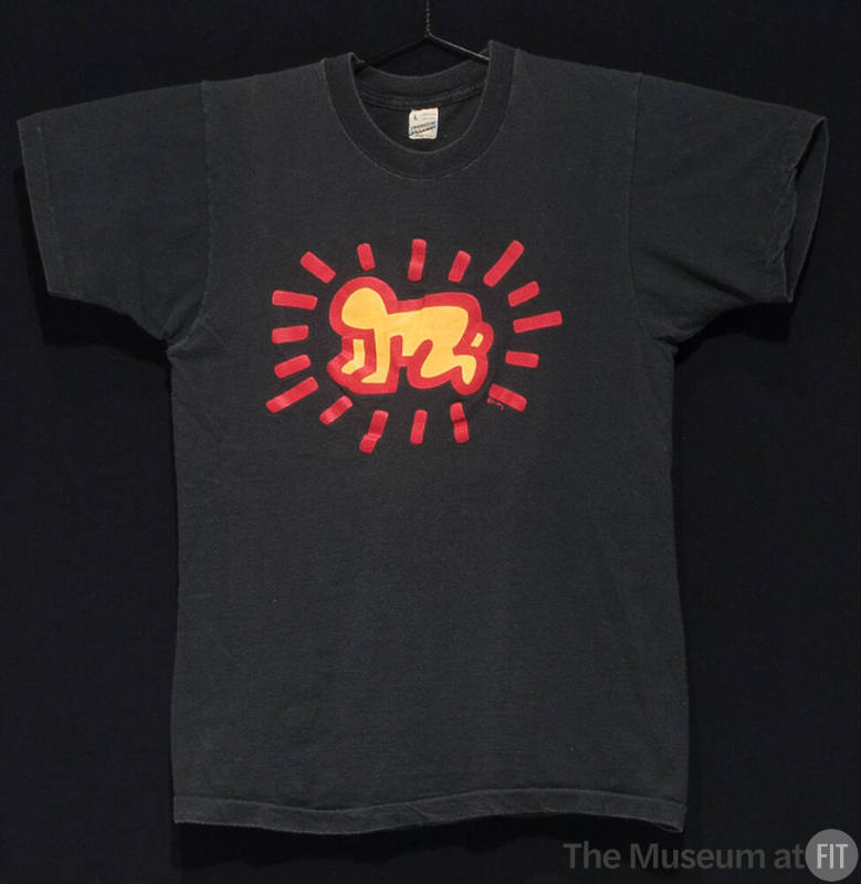 Black short sleeve t-shirt with center stylized red and yellow design of a crawling baby surrou…