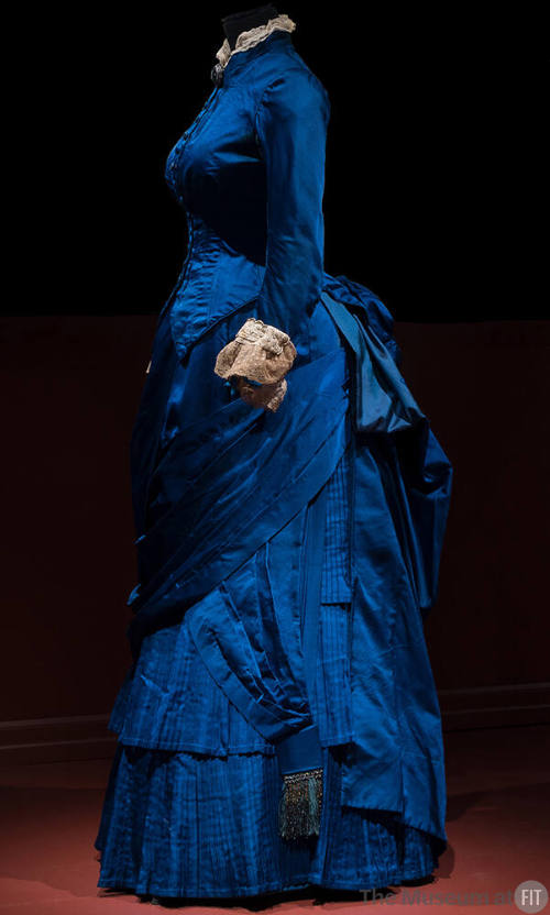 Blue two-piece floor length dress with long sleeves, beige lace trim at collar and cuffs and dr…