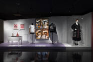 Doll Dressing exhibition installation view of three dressed mannequins, a large photograph and …