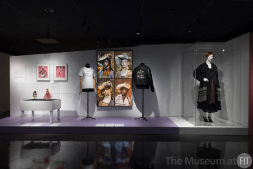 Doll Dressing exhibition installation view of three dressed mannequins, a large photograph and …