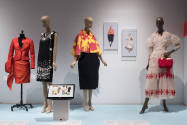 Doll Dressing exhibition installation view of four dressed mannequins and a monitor on a platfo…