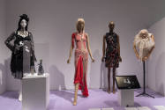 Doll Dressing exhibition installation view of four dressed mannequins, a doll in a case and a m…