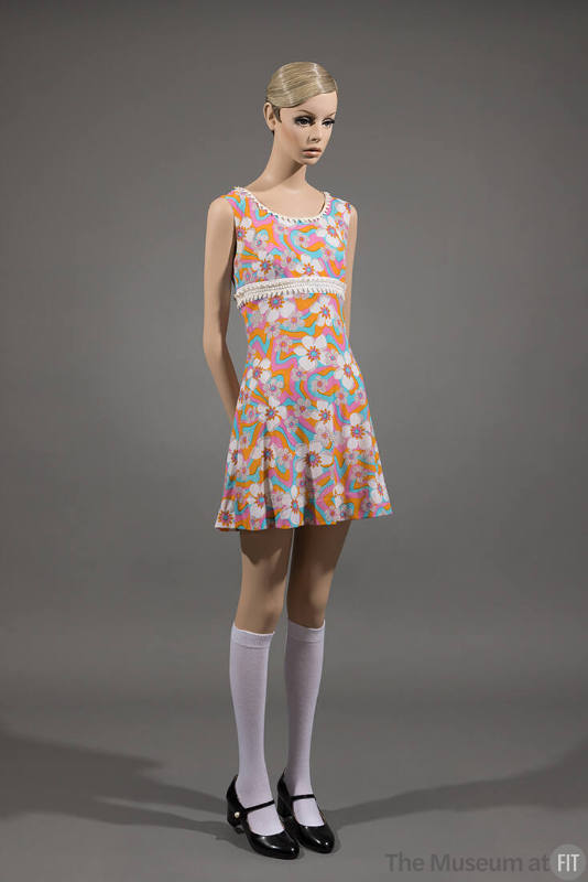 Orange, pink, blue and white floral sleeveless mini dress with white knee highs and black Mary …