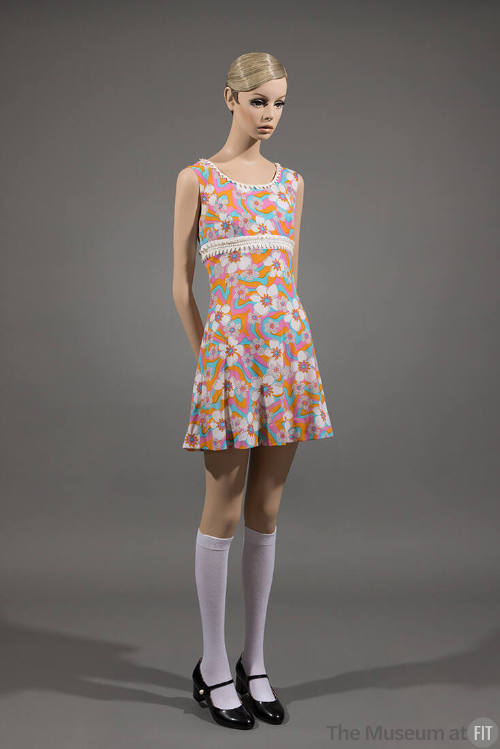 Orange, pink, blue and white floral sleeveless mini dress with white knee highs and black Mary …