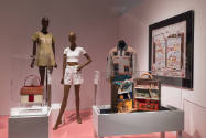 Doll Dressing exhibition installation view of three dressed mannequins with window print motifs…
