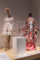Doll Dressing exhibition installation view of two mannequins in a pink Lolita ensemble and an a…