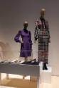 Doll Dressing exhibition installation view of two mannequins in a purple dress and a multicolor…