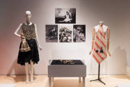Doll Dressing exhibition installation view of a mannequin in a black dress, a dress form with a…