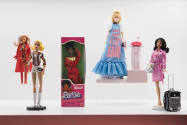 Doll Dressing exhibition installation view of a case with five fashion dolls in various ensembl…
