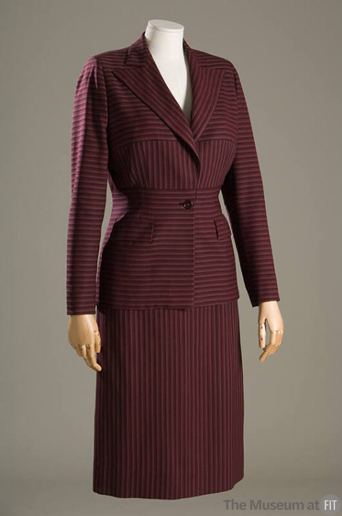 Purple and brown striped suit with horizontal and vertical stripe panels and calf length skirt
