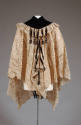 Back view of cream lace cape showing black velvet and gathered lace around neck/shoulders with …