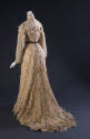 Back view of cream two-piece dress of flower-shaped cutwork and flared train