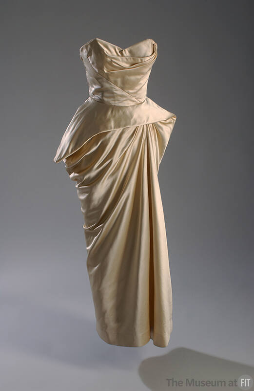Ivory strapless floor length evening dress with diagonally seamed bodice and asymmetrical struc…