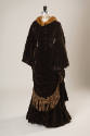 Brown velvet floor length dress with tassel trim on skirt and matching jacket with mink fur tri…