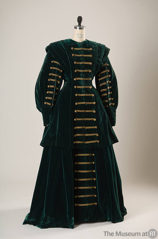Green velvet floor length suit with Hussar-style horizontal gold braid trim with buttons down f…