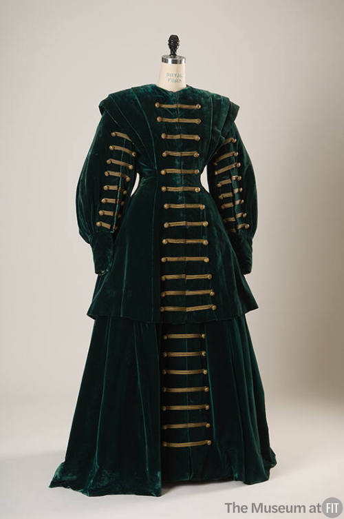 Green velvet floor length suit with Hussar-style horizontal gold braid trim with buttons down f…