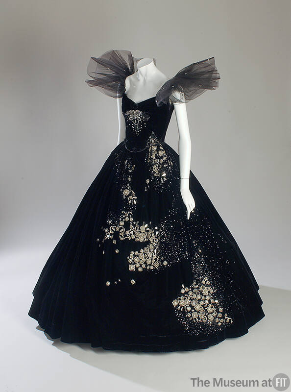 Black strapless two-piece dress with wide floor length flared skirt and oversize tulle ruffles …